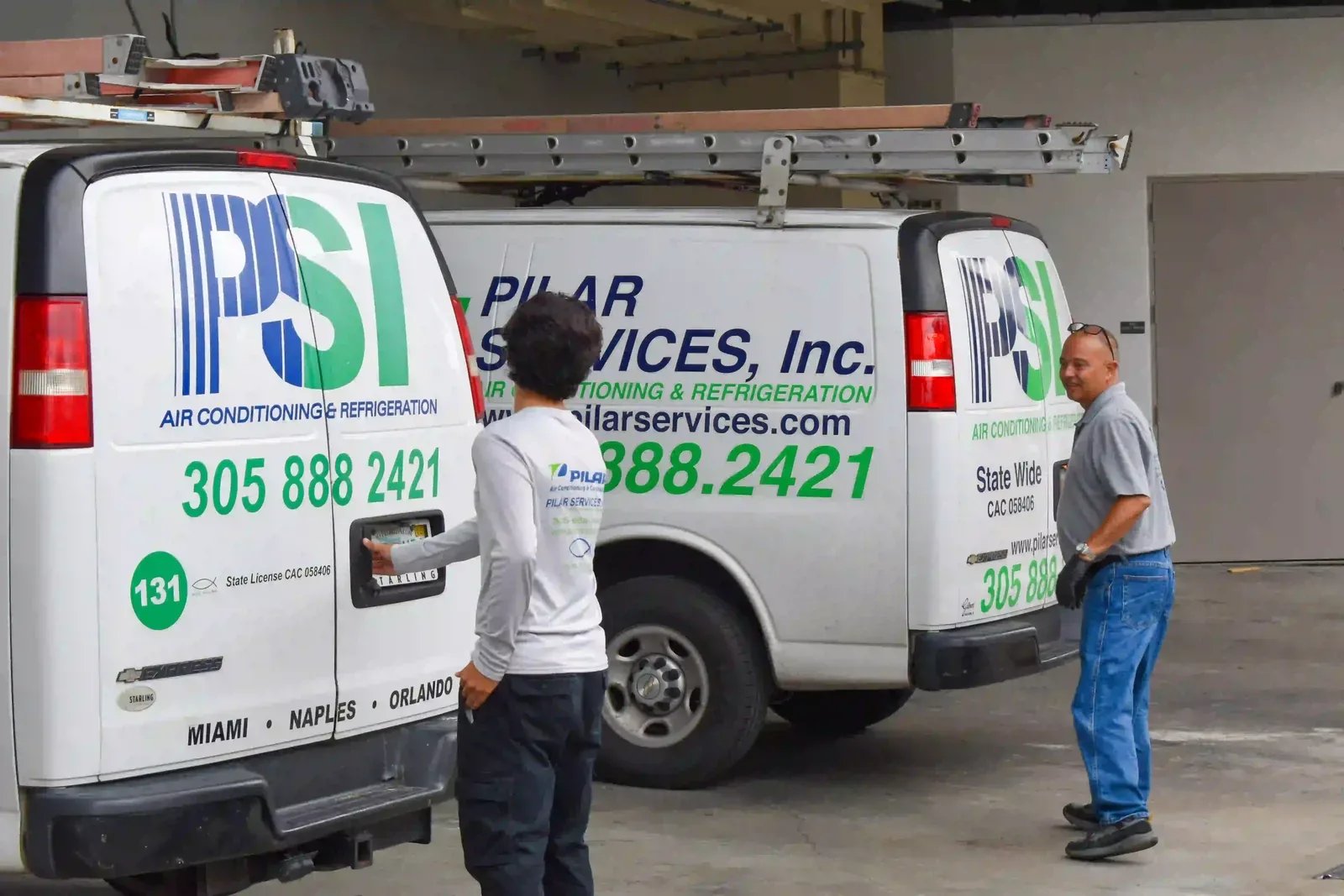 Pilar Services technician inspecting an A/C filter during routine maintenance