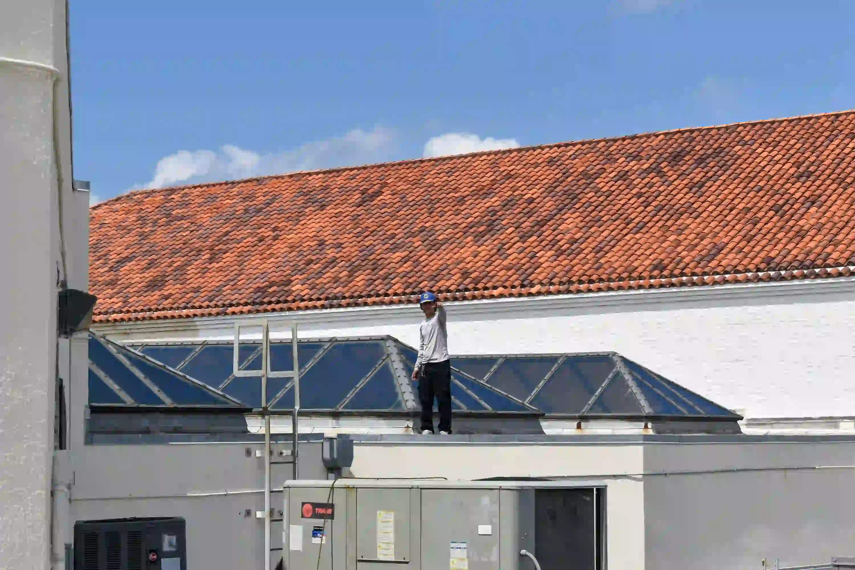 Pilar Services technician checking refrigerant on an outdoor A/C condenser