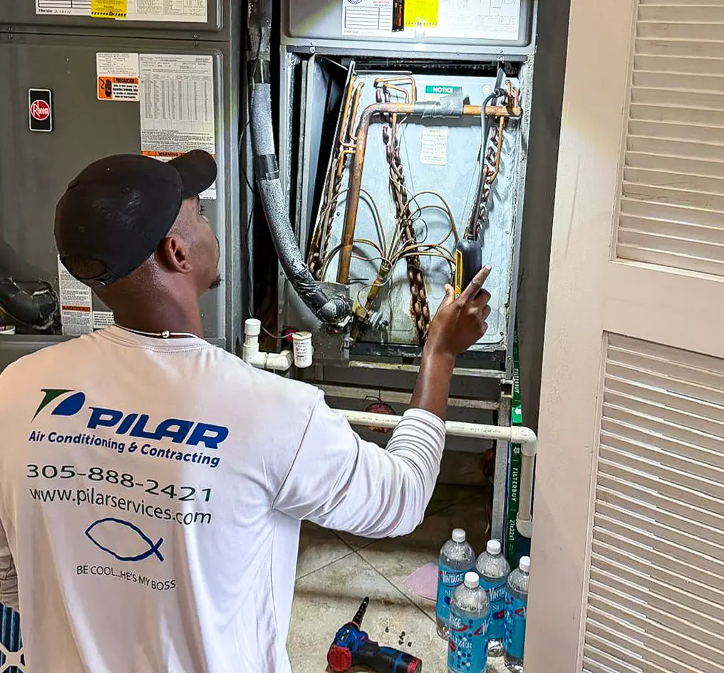 Pilar Services technician installing a new A/C condenser unit