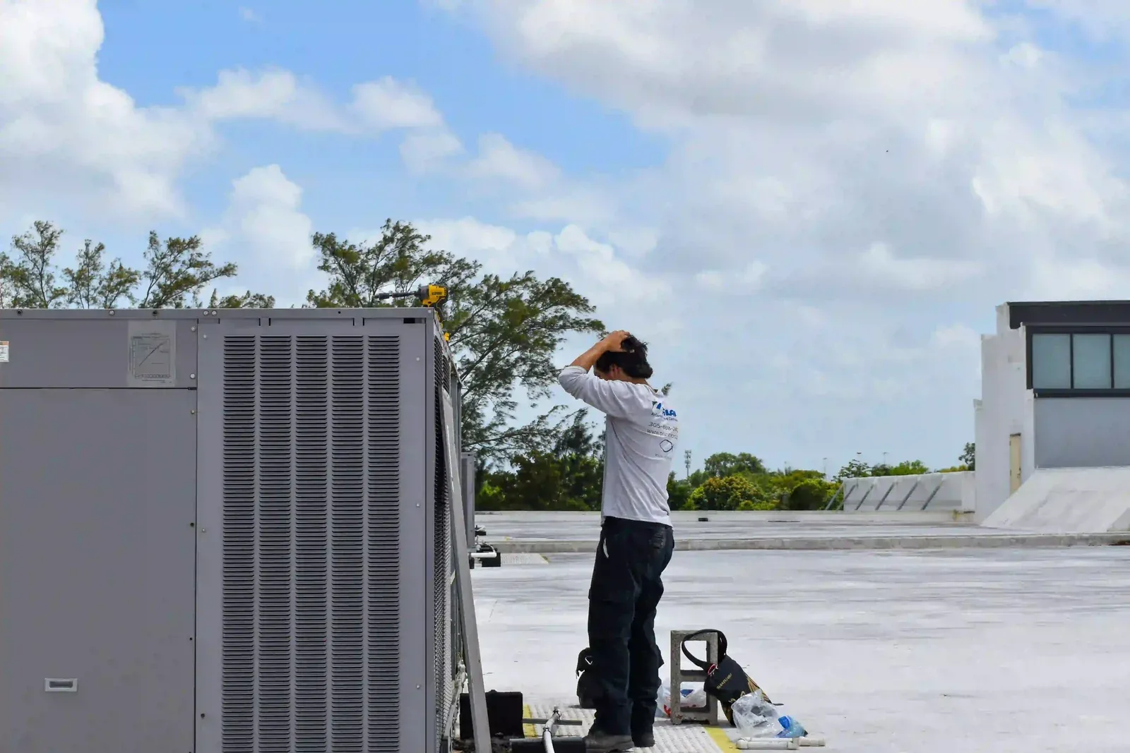 Pilar Services technician charging refrigerant on a newly installed A/C system